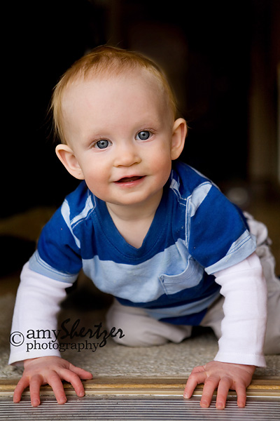 Blue-eyed baby crawling out the door of his Bozeman home.