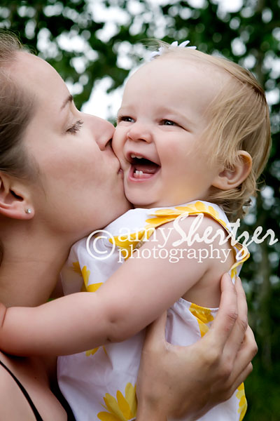 Bozeman mama gives kisses to a laughing baby girl