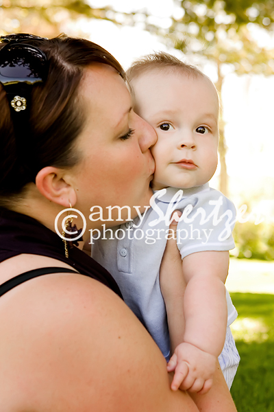 Baby boy gets a kiss from mom at a photo shoot in Bozeman, MT