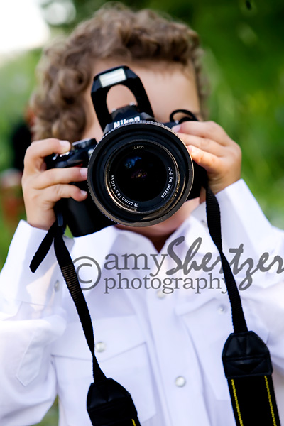 Preschooler takes a photograph with a Nikon