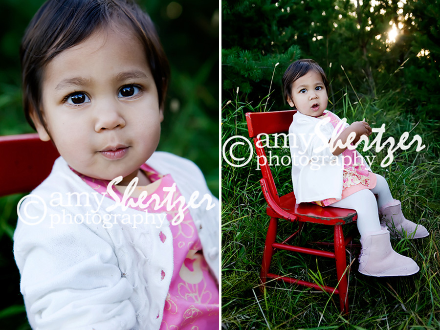 Beautiful Bozeman baby poses in a red chair for a photograph