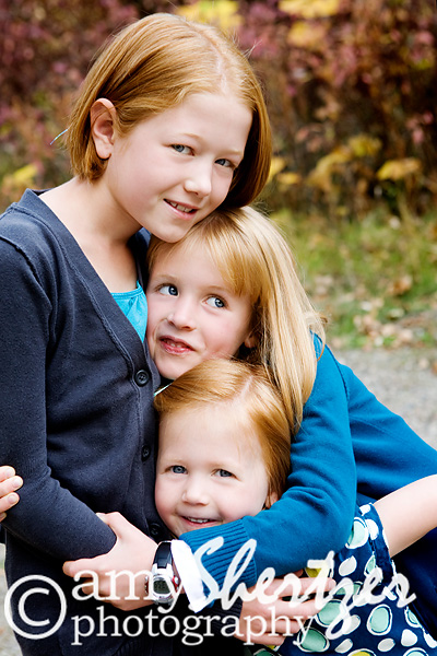 Loving hugs from 3 yound red-headed sisters