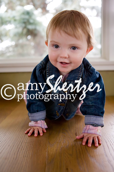 Baby girl smiles as she crawls toward the camera