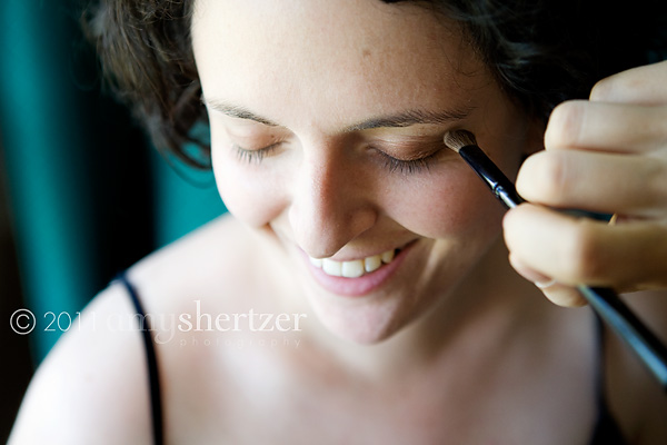 A bride has make-up applied prior to her wedding ceremony.