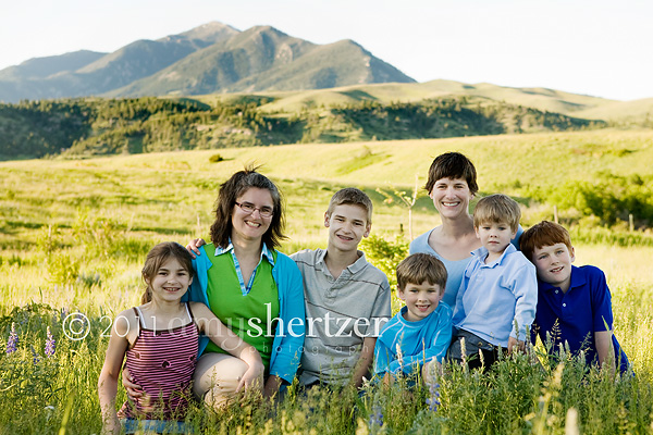 Two sisters pose with their children in front of the Bridger Mountains in Montana.