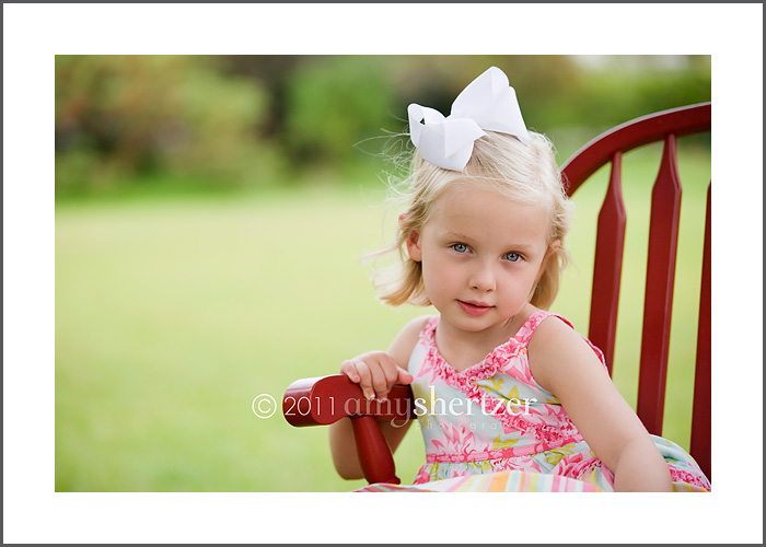 A sweet blond 5-year-old gives a serious look for a portrait.